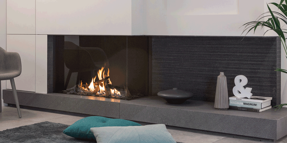 A modern fireplace with fire burning, insulated with PROMAFOUR® components