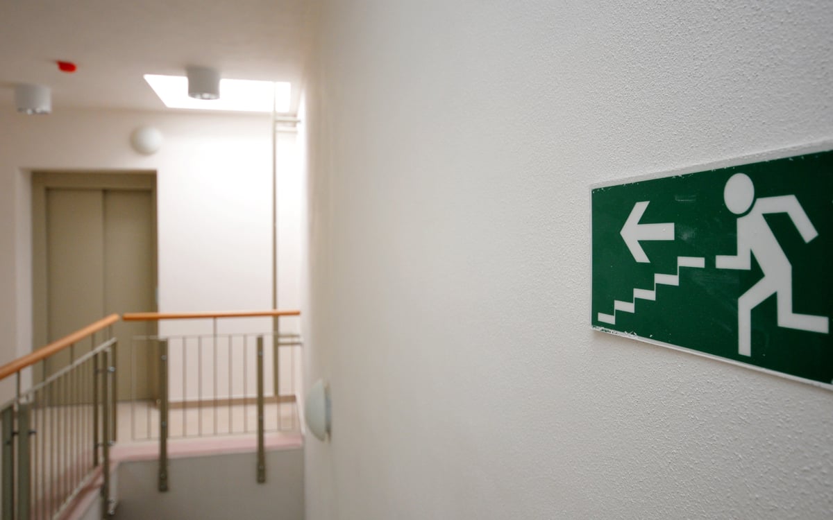 Emergency exit sign in a hallway of a newly built house